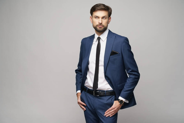 studio photo of young handsome businessman wearing suit - Fotó, kép