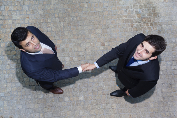 Business handshake between two businessman outdoors - Foto, afbeelding