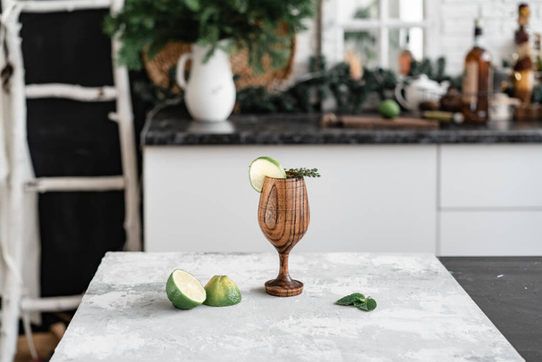 Wooden glass with a slice of lime - 写真・画像