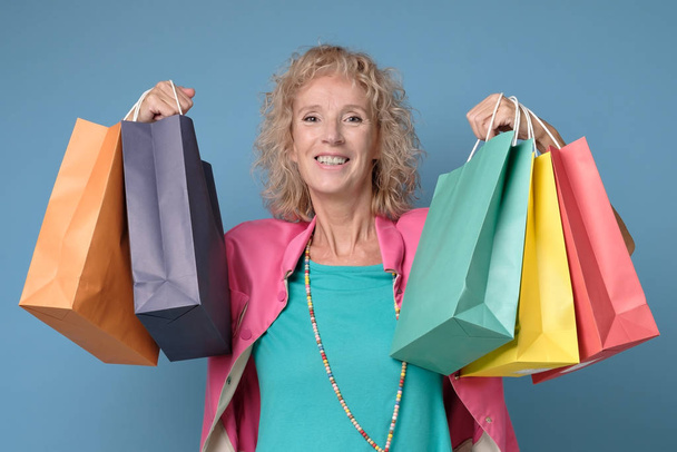 Caucasian beautiful mature woman posing with shopping bags - Fotografie, Obrázek