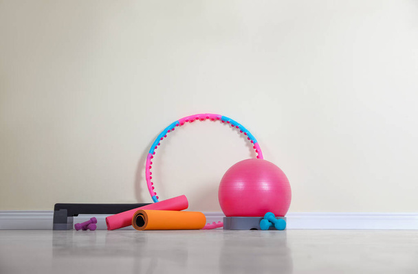 Different sports equipment near light wall in gym - Photo, Image