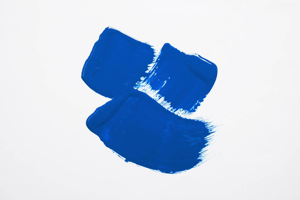 Paint strokes on white background background, top view. Color of the year 2020 (Classic blue) - Photo, image