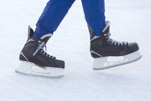 Legs of a man skating on an ice rink. Hobbies and sports. Vacati - Valokuva, kuva