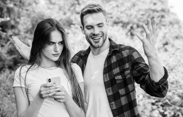 Woman use mobile phone. Mobile addicted. Social networks. Surfing internet. Buy online. Internet dependence. Guy and girl nature smartphone. She always online. Man jealous girlfriend messaging online - Foto, imagen