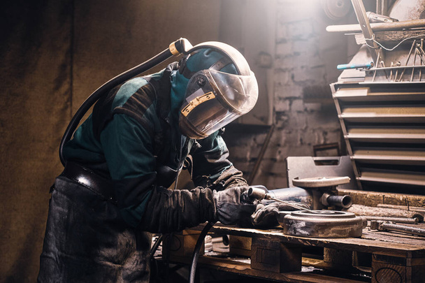 Busy man is working on metal factory - Foto, Imagen
