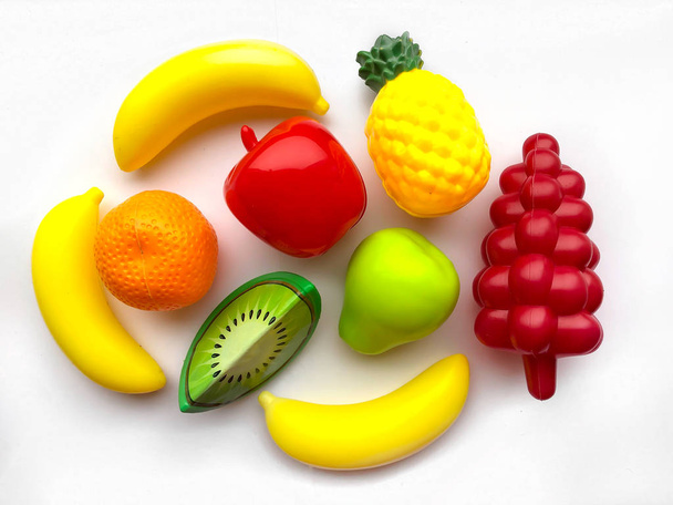 Bright colored plastic fruits for children, toys for children.  Educational toys for babies. Application in the design of catalogs of children's stores and more. - Photo, Image