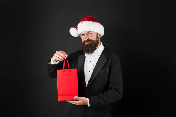 Serious Christmas shopping. Bearded man hold shopping bag. Director got ready for christmas and new year. Holiday preparation. Christmas sale. Merry Christmas. Happy new year, copy space - Фото, зображення