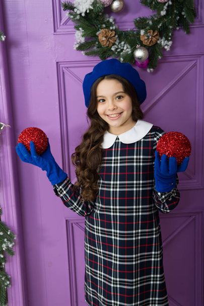 decorate home and christmas tree. happy new year. cheerful parisian girl in beret and gloves. winter holiday activity. season shopping. small french girl. stylish kid decorative xmas ball - Fotografie, Obrázek