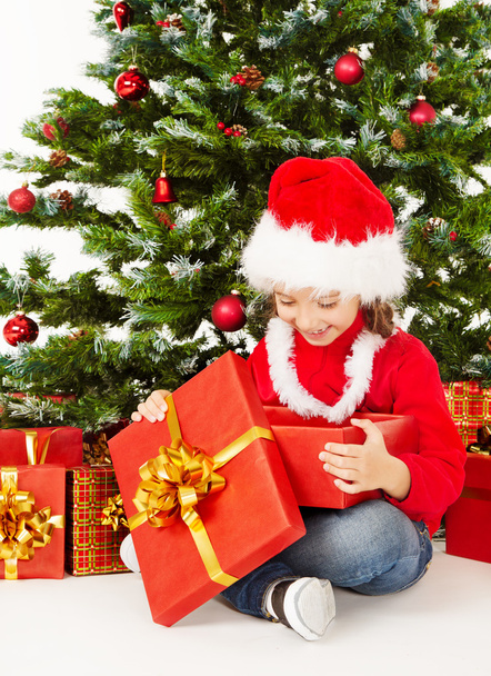 Christmas child open gift box under fir tree, - Foto, Imagem