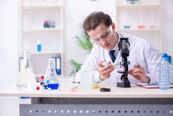 Young male chemist experimenting in lab - Photo, Image