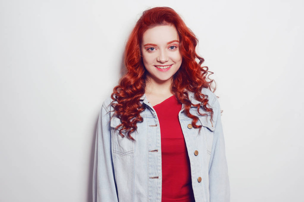 Portrait of beautiful cheerful redhead girl with flying curly ha - Zdjęcie, obraz