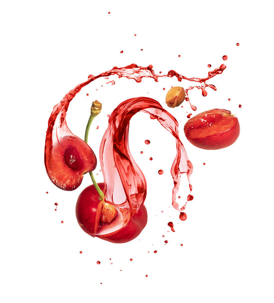 Juice splashes out from cutted cherries on a white background  - Foto, afbeelding