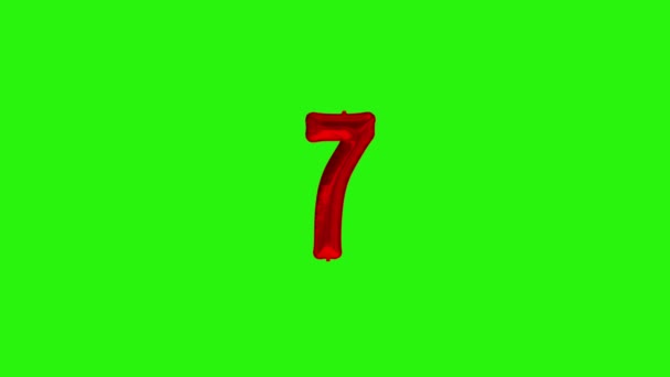 Number 7 seven seventh year celebration red foil balloon floating on green - Footage, Video