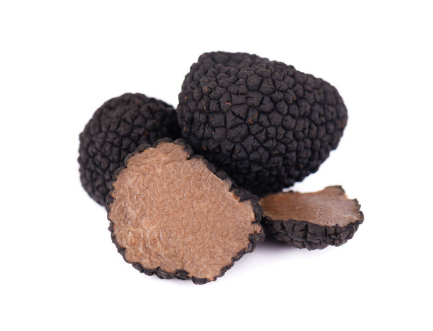 Black truffles isolated on a white background. Fresh sliced truffle. Delicacy exclusive truffle mushroom. Piquant and fragrant French delicacy. Clipping path. - 写真・画像