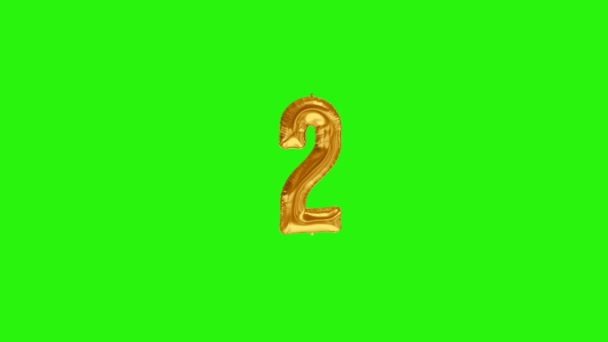 Νούμερο 2 δύο δεύτερο έτος εορτασμού χρυσό αλουμινόχαρτο μπαλόνι επιπλέει στο πράσινο - Πλάνα, βίντεο