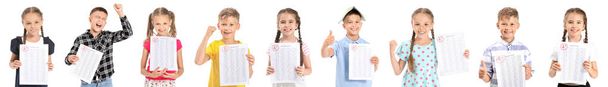 Szczęśliwe dzieci z wynikami testu szkolnego na białym tle - Zdjęcie, obraz