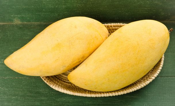 Fresh golden mango in basket - 写真・画像