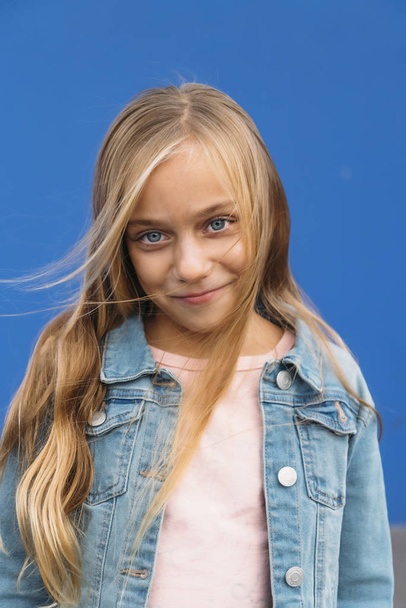 Portrait of little blond girl with blue eyes - Фото, изображение