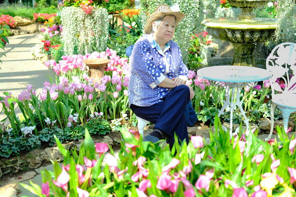 idős nő a kertben pihenő. idős női relaxáló lepipál - Fotó, kép