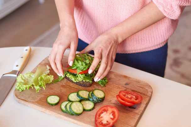 Woman hands making a healthy sandwich - Photo, image