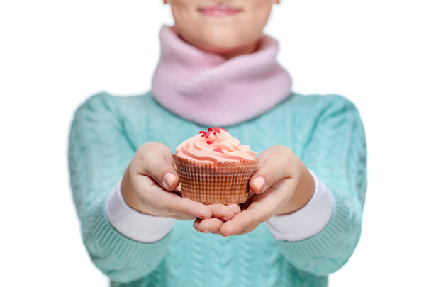 Woman holding a pink cupcake on white - Φωτογραφία, εικόνα