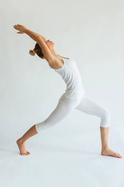 blonde beautiful cheerful woman doing yoga asanas. Healthy lifestyle and sport concept - Photo, Image