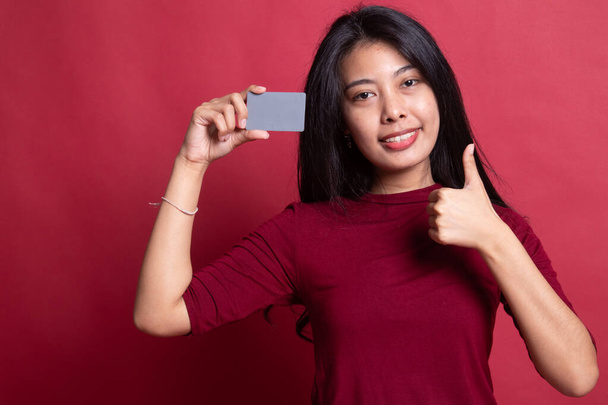 Young Asian woman thumbs up with a blank card. - Fotó, kép