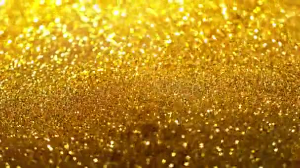 Movimento super lento de partículas douradas brilhantes sobre fundo preto. Profundidade de foco rasa. Filmado em câmera de cinema de alta velocidade, 1000 fps. - Filmagem, Vídeo