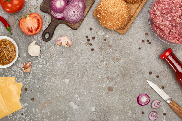 top view of fresh burger ingredients on grey concrete surface - Photo, Image