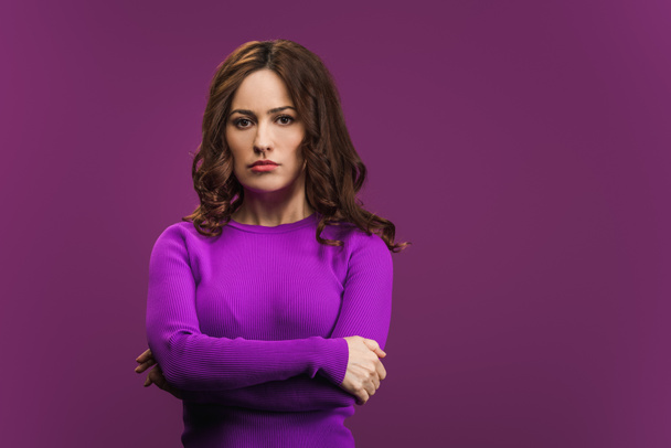 displeased woman standing with crossed arms on purple background - Valokuva, kuva
