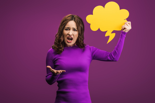 mujer irritada gritando mientras sostiene la burbuja del pensamiento sobre fondo púrpura
 - Foto, Imagen