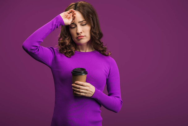 fille épuisée touchant le front tout en tenant du café pour aller sur fond violet
 - Photo, image