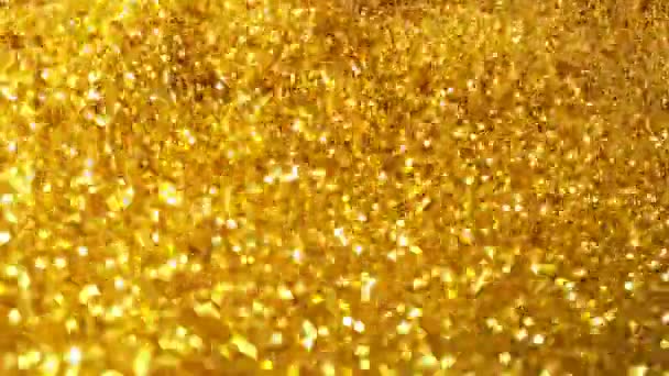 Movimento super lento de partículas douradas brilhantes sobre fundo preto. Profundidade de foco rasa. Filmado em câmera de cinema de alta velocidade, 1000 fps. - Filmagem, Vídeo