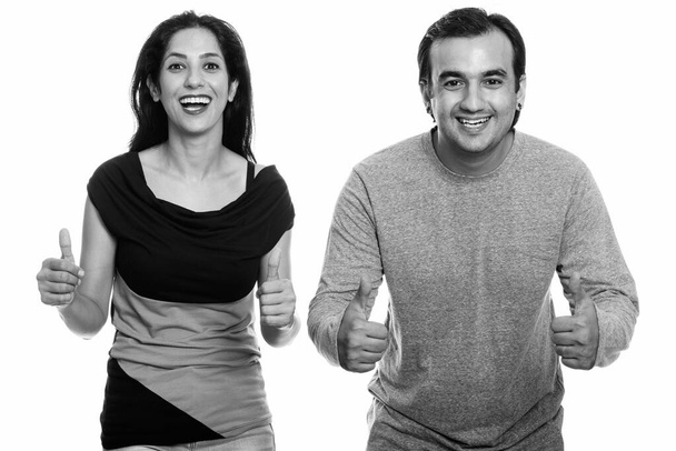 Studio záběr snoubence perské usmívá a dávat palce společně v černé a bílé - Fotografie, Obrázek