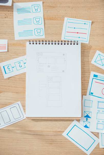 Top view of ux website wireframe sketches and planning applications on wooden table - Foto, Imagem