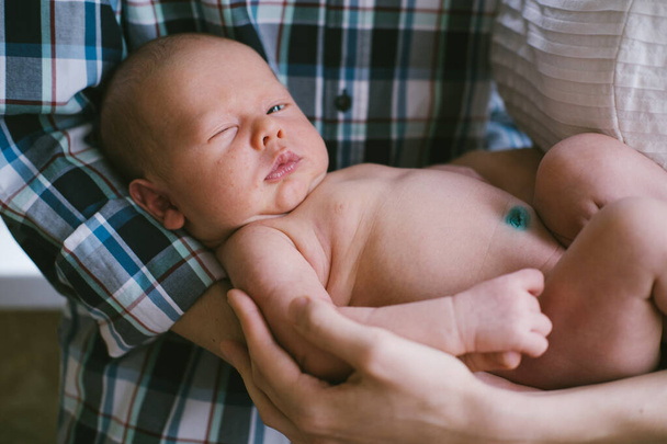 Close up portrait of little newborn baby boy on parents hands  - Photo, Image