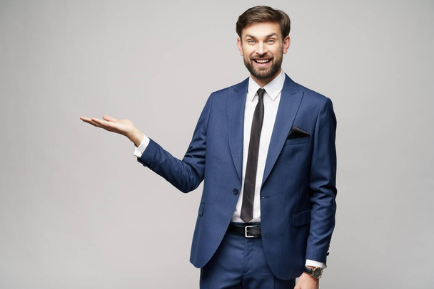 Portrait of a young businessman pointing on a copyspace with his finger - Foto, afbeelding