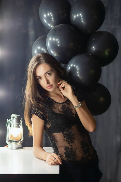 Adorable young brunette posing near a table - Photo, Image