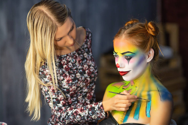The artist applies body art to a charming woman - Photo, Image