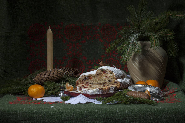 Christmas stollen with candied fruit and raisins on a festive table - Photo, Image