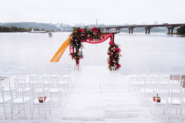 Chairs and beautiful wedding decoration on river shore in Kyiv, Ukraine - Photo, Image