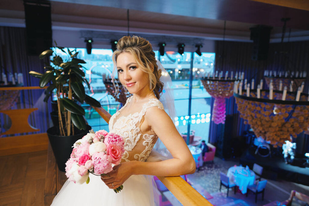 Portrait of bride posing on blurred restaurant interior - Фото, изображение
