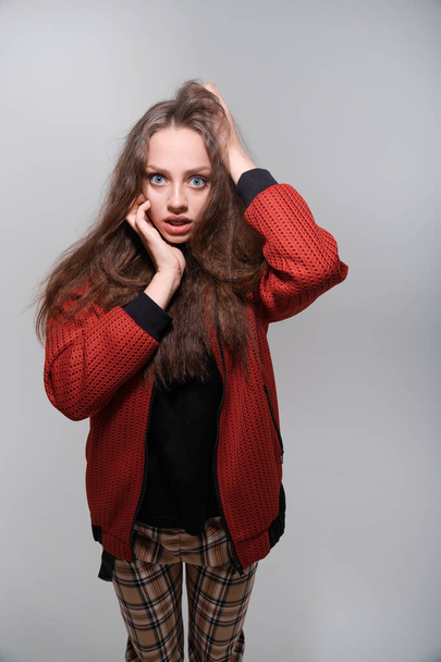 Teenager girl making faces having fun posing in studio - Foto, afbeelding