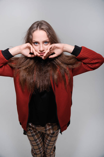 Teenager girl making faces having fun posing in studio - Fotografie, Obrázek