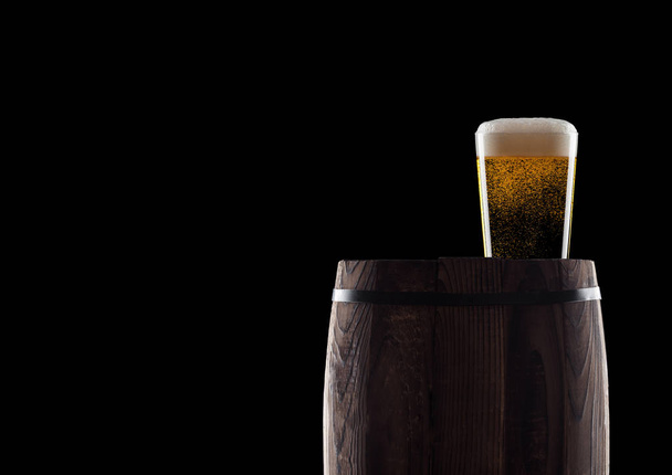 Cold glass of craft beer on old wooden barrel - Φωτογραφία, εικόνα