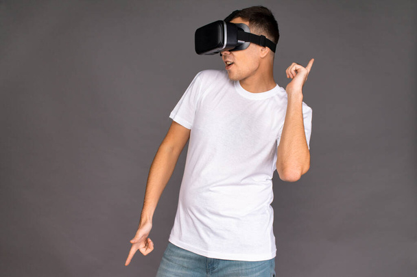 A guy in virtual reality glasses is dancing. Future and modern technologies - Φωτογραφία, εικόνα