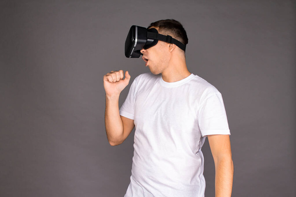A guy in virtual reality glasses is dancing. Future and modern technologies - Photo, Image