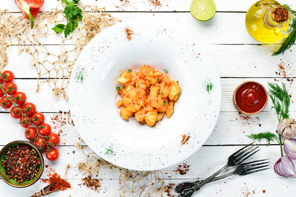 Roasted cauliflower with chili sauce on a plate. Top view. free space for your text. Rustic style. - Photo, Image