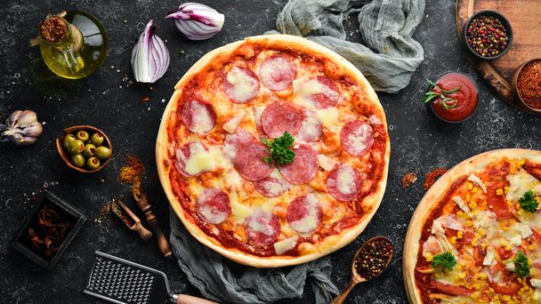 Traditional pizza with salami sausage and mozzarella. Top view. free space for your text. Rustic style. - Foto, imagen