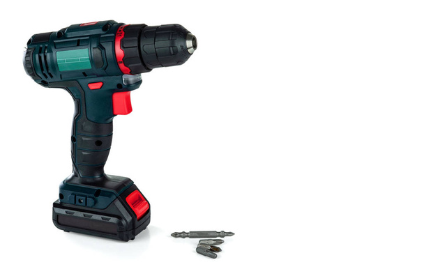 Cordless drill and a set of different drills bits isolated on a white background.  - Photo, Image